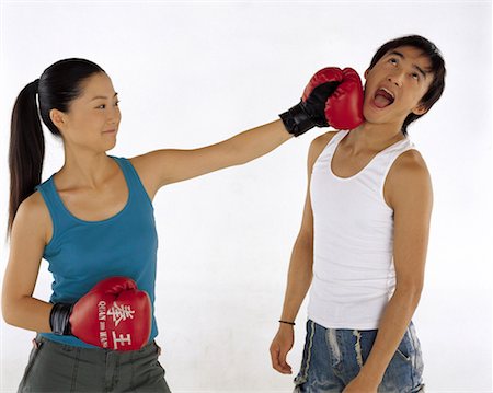 Woman punching msn with boxing gloves Stock Photo - Premium Royalty-Free, Code: 642-01736539