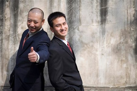 formal jackets for men - Office men standing in front of a wall Stock Photo - Premium Royalty-Free, Code: 642-01736609