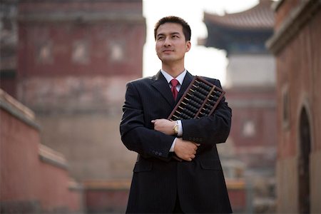 Young man holding abacus Stock Photo - Premium Royalty-Free, Code: 642-01736612