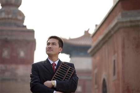 Young man holding abacus Stock Photo - Premium Royalty-Free, Code: 642-01736613