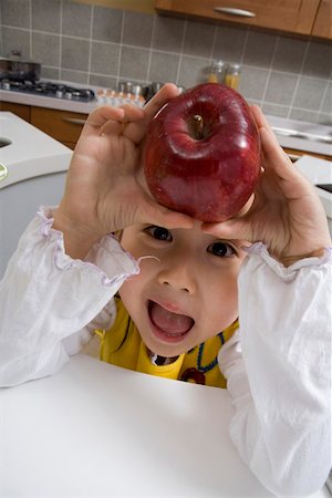 simsearch:642-01734328,k - Portrait of a girl holding apple Stock Photo - Premium Royalty-Free, Code: 642-01736659