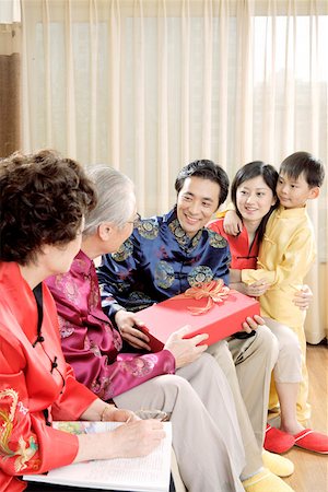 Junior giving present to eldership Stock Photo - Premium Royalty-Free, Code: 642-01736951