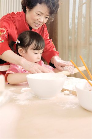 Girl with grandmother preparing food Stock Photo - Premium Royalty-Free, Code: 642-01736962