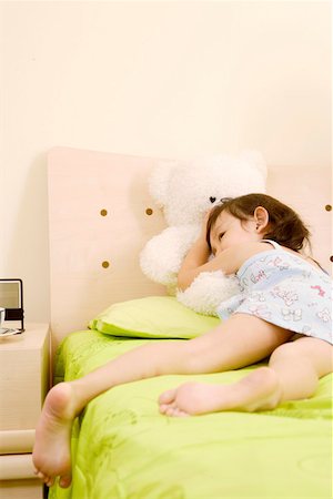 Girl lying on bed Stock Photo - Premium Royalty-Free, Code: 642-01736976