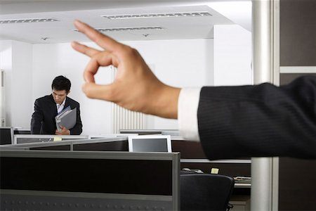 pen two hands - Close-up of human hand while businessman standing in background Stock Photo - Premium Royalty-Free, Code: 642-01737149