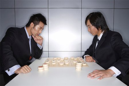 simsearch:642-01737144,k - Young men playing Chinese chess Stock Photo - Premium Royalty-Free, Code: 642-01737142