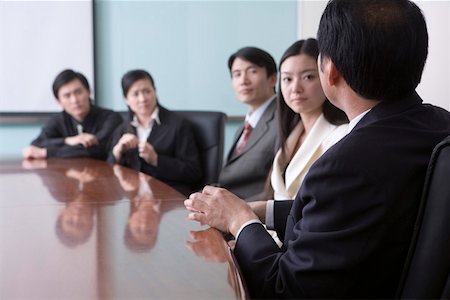 Business people sitting by table in a office, discussing Stock Photo - Premium Royalty-Free, Code: 642-01737494