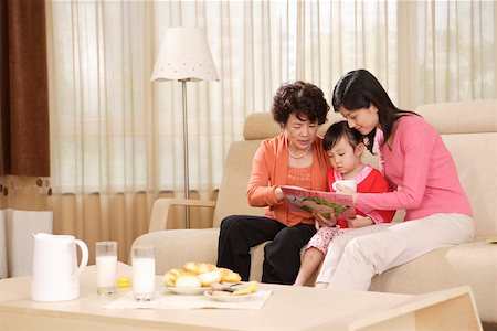 Grandmother and mother reading book to daughter Stock Photo - Premium Royalty-Free, Code: 642-01737577