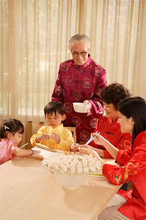 Whole family making dumplings at home Stock Photo - Premium Royalty-Free, Code: 642-01737585