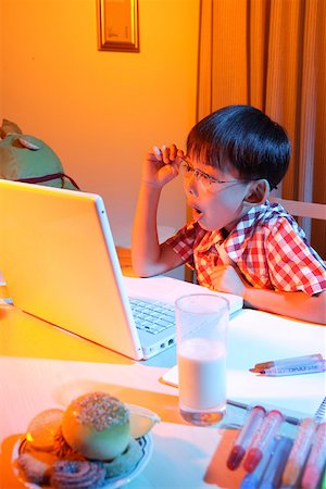 simsearch:642-01732852,k - Boy sitting by laptop, making face Stock Photo - Premium Royalty-Free, Code: 642-01737587