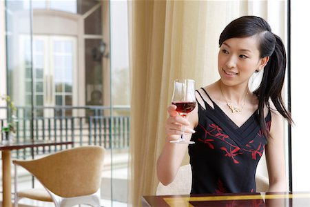 simsearch:642-01737214,k - Young woman holding wine glass in restaurant Stock Photo - Premium Royalty-Free, Code: 642-01737641
