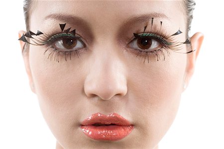 Close-up of a young woman wearing lipstick and false eyelashes Stock Photo - Premium Royalty-Free, Code: 642-01732669