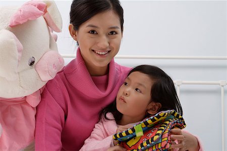 stuffed animals bunny - Mother and daughter with stuffed toy, smiling, portrait Stock Photo - Premium Royalty-Free, Code: 642-01732740