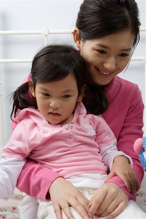 simsearch:642-01732852,k - Mother sitting with daughter, smiling Stock Photo - Premium Royalty-Free, Code: 642-01732758