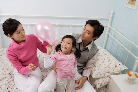 simsearch:642-01734328,k - Young couple playing with their daughter in the bedroom, elevated view Stock Photo - Premium Royalty-Free, Code: 642-01732750