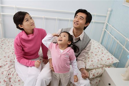 simsearch:642-01734328,k - Young couple playing with their daughter in the bedroom Stock Photo - Premium Royalty-Free, Code: 642-01732752