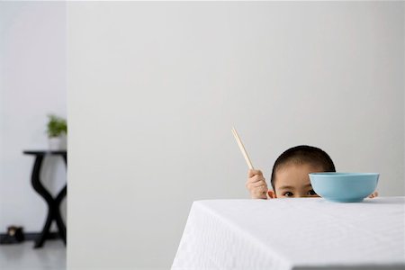 simsearch:642-01732852,k - Boy holding chopsticks at dining table, portrait Stock Photo - Premium Royalty-Free, Code: 642-01732851