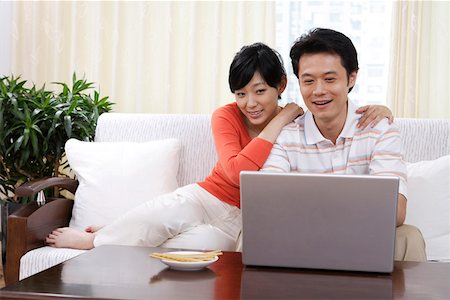 Young couple looking at laptop in intimacy Stock Photo - Premium Royalty-Free, Code: 642-01732923
