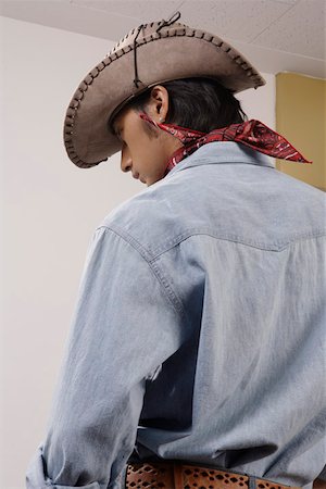 fashions cowboys for male - Close-up of a young man wearing cowboy hat Stock Photo - Premium Royalty-Free, Code: 642-01733187