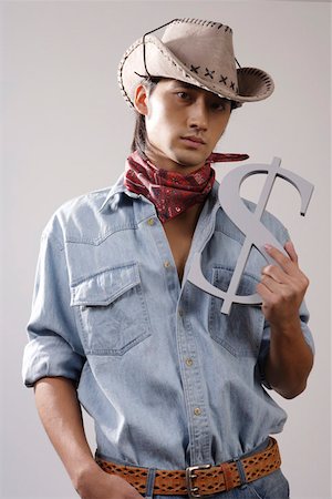 fashions cowboys for male - Close-up of a young man holding dollar sign Stock Photo - Premium Royalty-Free, Code: 642-01733189