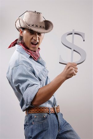 forex - Cowboy holding a dollar symbol Stock Photo - Premium Royalty-Free, Code: 642-01733194