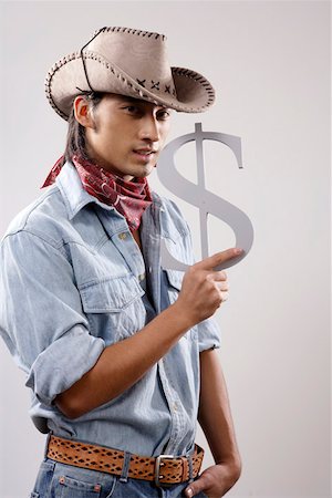 fashions cowboys for male - Close-up of a young man holding dollar sign Stock Photo - Premium Royalty-Free, Code: 642-01733192