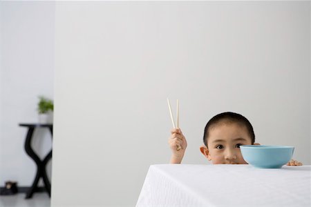 simsearch:642-01732733,k - Boy holding chopsticks by table Foto de stock - Royalty Free Premium, Número: 642-01733298