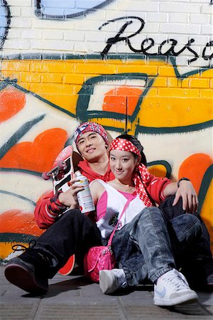 spray paint woman - Young couple with skateboard and spray by graffiti wall, portrait Stock Photo - Premium Royalty-Free, Code: 642-01733370