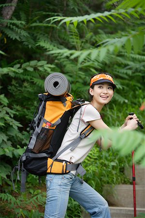 stair sports - Young woman hiking in a forest, smiling Stock Photo - Premium Royalty-Free, Code: 642-01733824