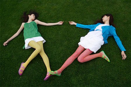 friends sleeping together - Young women posing on lawn Stock Photo - Premium Royalty-Free, Code: 642-01733962