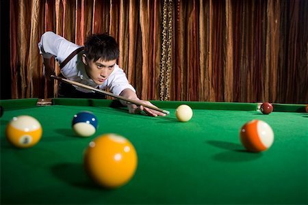 pool sticks - one man playing billiards Stock Photo - Premium Royalty-Free, Code: 642-02004853