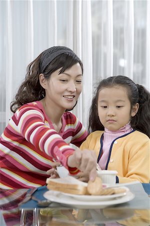 a girl and her mother taking breakfast Stock Photo - Premium Royalty-Free, Code: 642-02005951