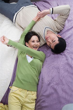 a couple lying on the bed Stock Photo - Premium Royalty-Free, Code: 642-02006130