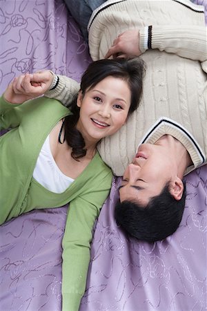 a couple lying on the bed Stock Photo - Premium Royalty-Free, Code: 642-02006131
