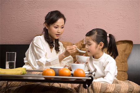 mother and her daughter taking food Stock Photo - Premium Royalty-Free, Code: 642-02006157