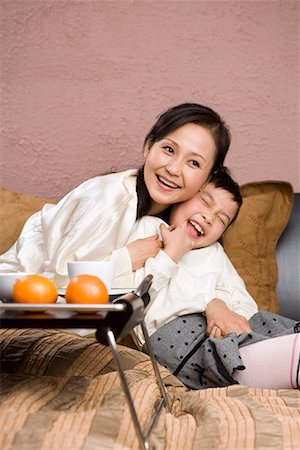 mother and her daughter lying on the bed Stock Photo - Premium Royalty-Free, Code: 642-02006159