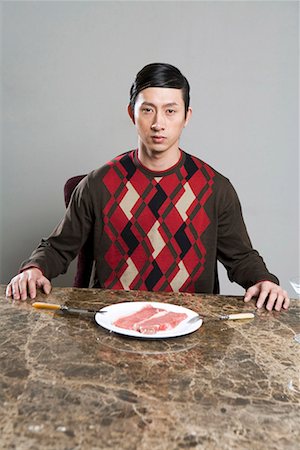 people eating raw meat - a fasionable man eating western food Stock Photo - Premium Royalty-Free, Code: 642-02006234