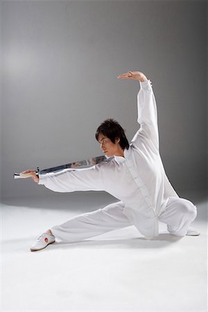 a man practicing a Chinese sword Stock Photo - Premium Royalty-Free, Code: 642-02006341