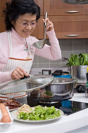 a middle-aged housewife cooking Stock Photo - Premium Royalty-Free, Code: 642-02006696