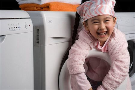 family with washing machine - a girl Stock Photo - Premium Royalty-Free, Code: 642-02033655