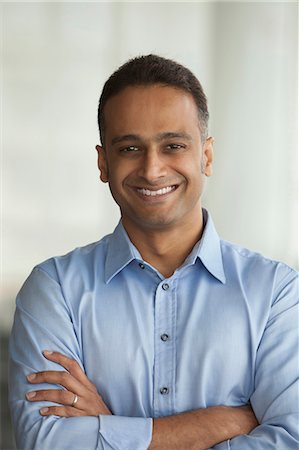 portrait 40s indian man one person - Singapore, Smiling businessman standing with arms crossed Stock Photo - Premium Royalty-Free, Code: 655-08356885