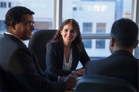 simsearch:655-08357080,k - Singapore, Three smiling business people at conference table Stock Photo - Premium Royalty-Free, Code: 655-08356955