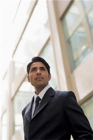 simsearch:693-03311509,k - Businessman outside office building looking past camera Stock Photo - Premium Royalty-Free, Code: 655-08357074