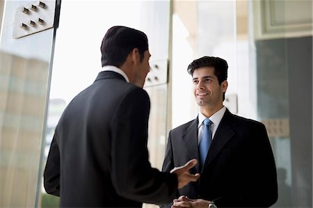 simsearch:655-08357080,k - India, Two businessmen in suits talking Stock Photo - Premium Royalty-Free, Code: 655-08357081