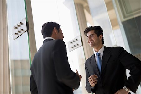 simsearch:655-08357080,k - India, Two businessmen in suits talking Stock Photo - Premium Royalty-Free, Code: 655-08357082