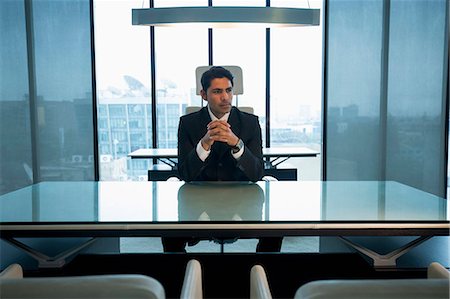 simsearch:655-08357080,k - India, Businessman sitting at desk with hands clasped in office Stock Photo - Premium Royalty-Free, Code: 655-08357108