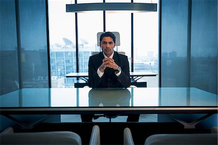 simsearch:655-08357080,k - India, Businessman sitting at desk with hands clasped in office Stock Photo - Premium Royalty-Free, Code: 655-08357109