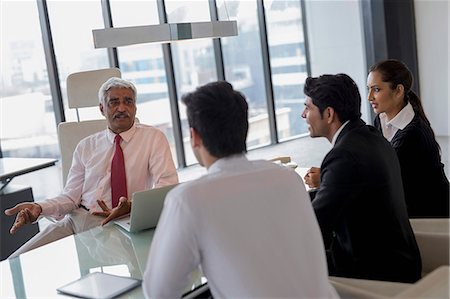 simsearch:655-08357080,k - India, Senior businessman leading discussion with three colleagues Stock Photo - Premium Royalty-Free, Code: 655-08357100