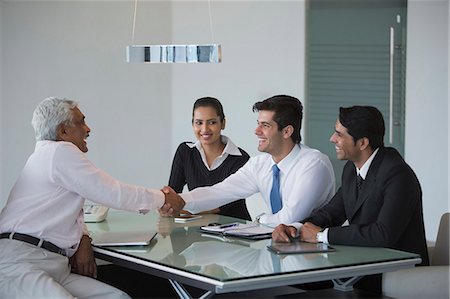 India, Senior businessman shakes hand of younger man in meeting Stock Photo - Premium Royalty-Free, Code: 655-08357102