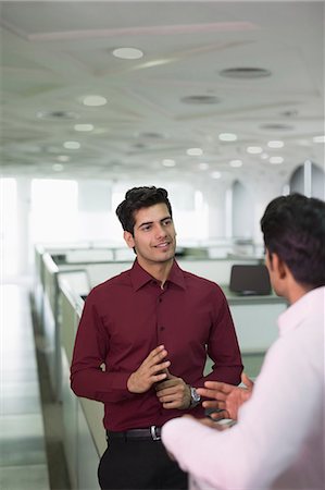 simsearch:655-08357080,k - India, Two male colleagues talking in office Stock Photo - Premium Royalty-Free, Code: 655-08357110